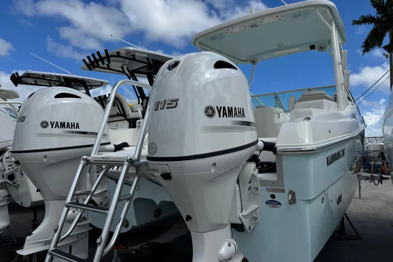 Slide: The Image of 2026 World Cat 230 SD boat with dual Yamaha 115 engines, docked under blue sky. - 3