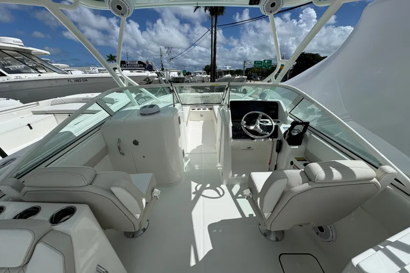 Slide: The Image of Interior view of 2026 World Cat 230 SD boat, featuring modern helm and seating. - 7