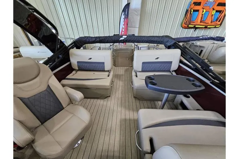 Slide: The Image of 2024 Starcraft CX 23 RL boat interior with luxurious seating and table setup. - 4