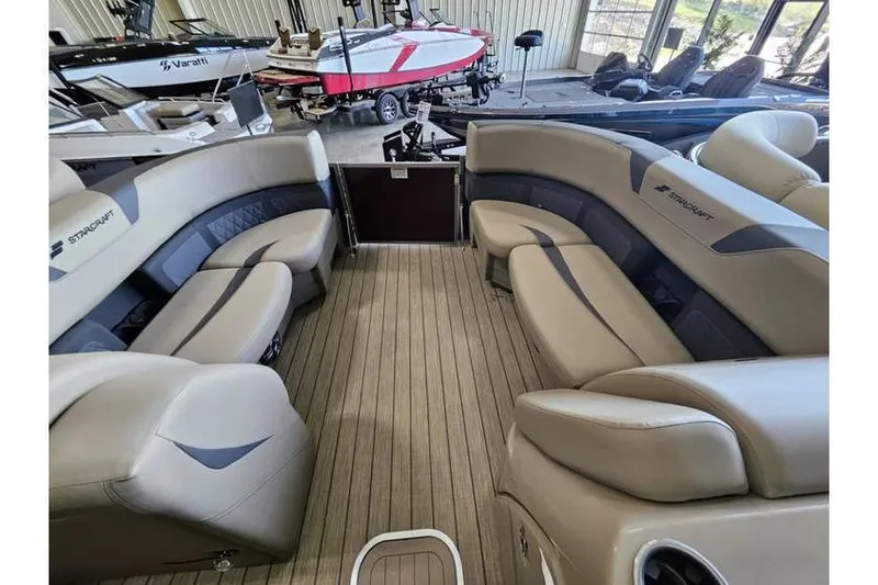 Slide: The Image of 2024 Starcraft CX 23 RL boat interior with luxurious seating and wood-style flooring. - 5