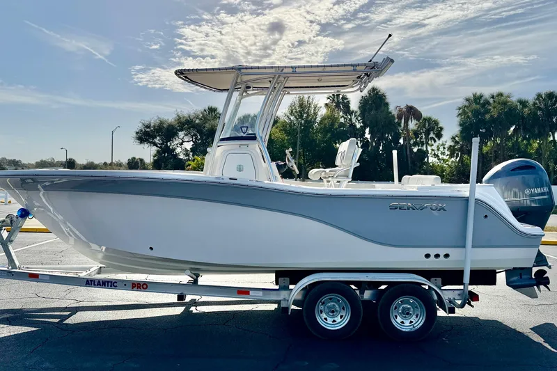 The Image of 2023 Sea Fox 228 Commander boat on trailer, parked outdoors under a clear sky. - 0