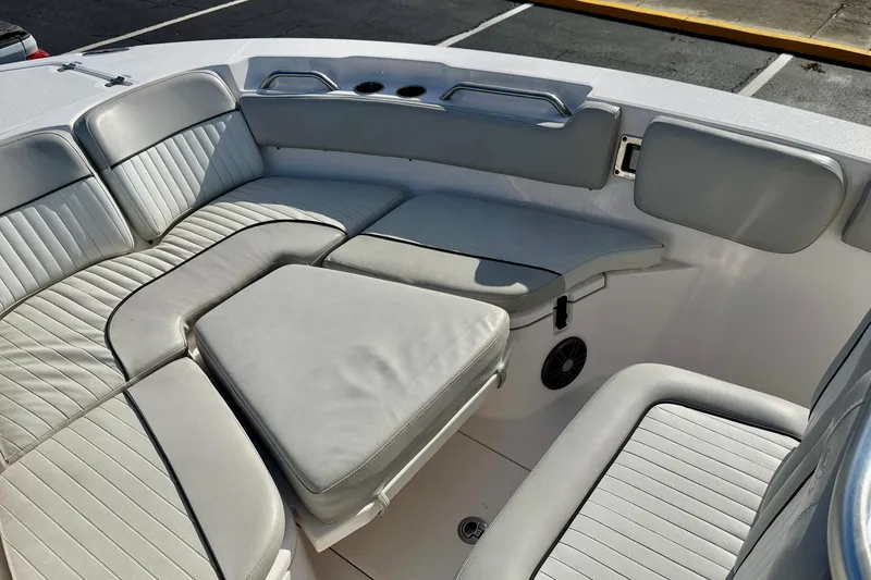 Slide: The Image of 2023 Sea Fox 228 Commander boat interior with cushioned seating and cup holders. - 13