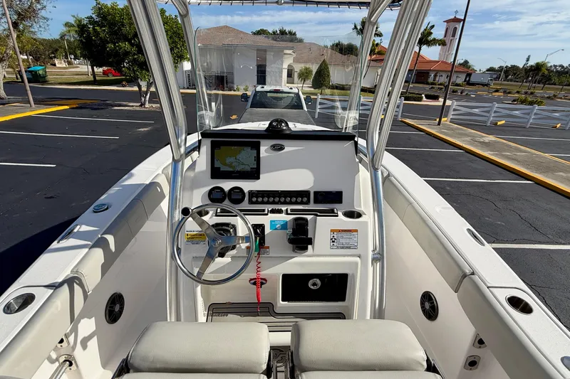 Slide: The Image of 2023 Sea Fox 228 Commander boat dashboard with steering wheel and navigation display. - 21