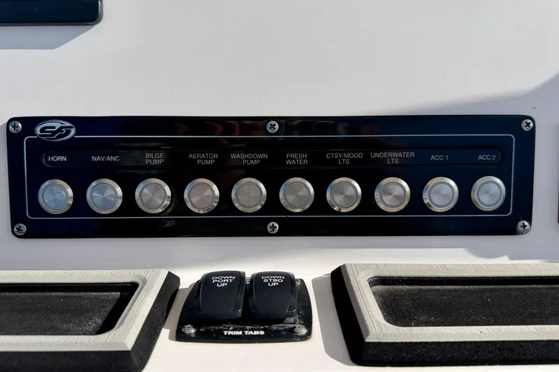 Slide: The Image of Control panel of 2023 Sea Fox 228 Commander boat with various switches and trim tabs. - 25