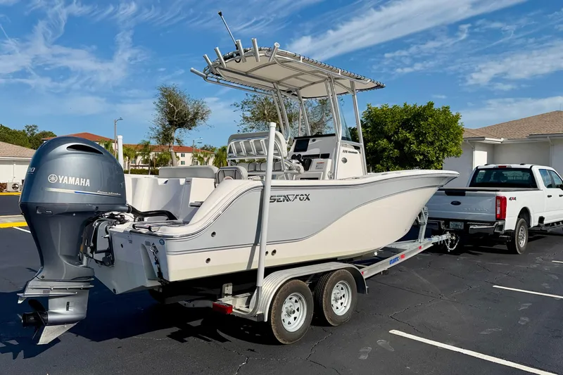 Slide: The Image of 2023 Sea Fox 228 Commander boat on trailer, attached to a white truck. - 4