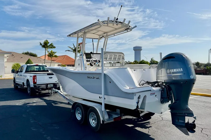 Slide: The Image of 2023 Sea Fox 228 Commander boat on trailer, attached to a white truck. - 6