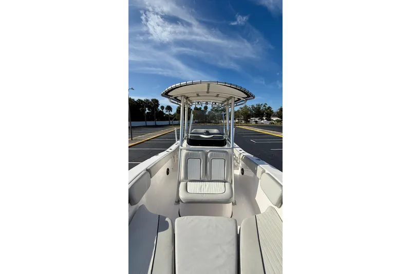 Slide: The Image of 2023 Sea Fox 228 Commander boat interior with seating and canopy under blue sky. - 7