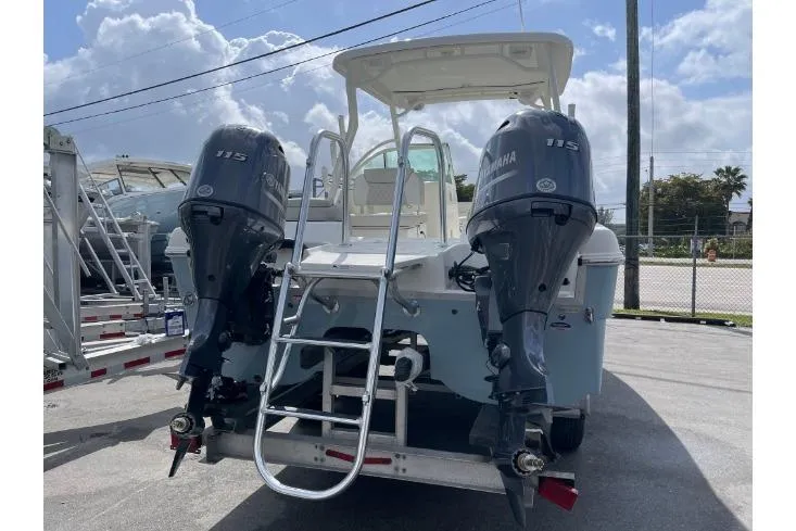 Slide: The Image of 2025 World Cat 230 DC boat with dual Yamaha 115 engines, rear view. - 4