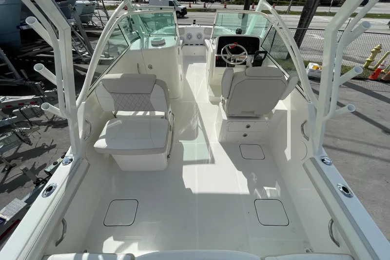 Slide: The Image of 2025 World Cat 230 DC boat interior with seating and steering console. - 6