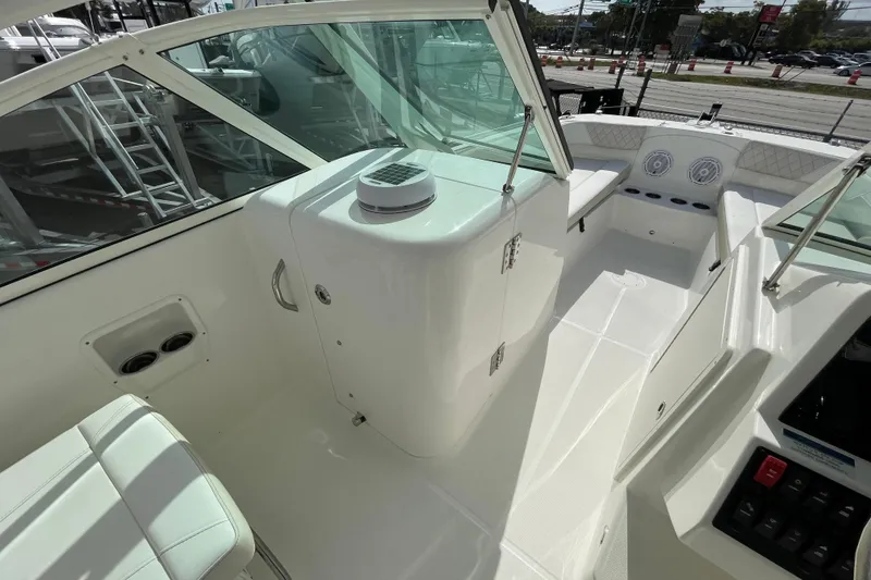 Slide: The Image of 2025 World Cat 230 DC boat interior with seating and control panel. - 9