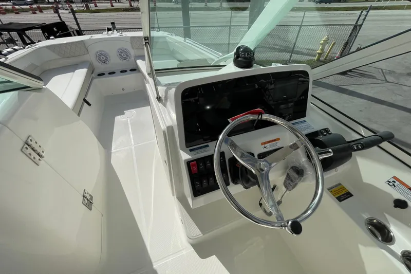 Slide: The Image of 2026 World Cat 230 DC boat interior with seating and storage compartments. - 10