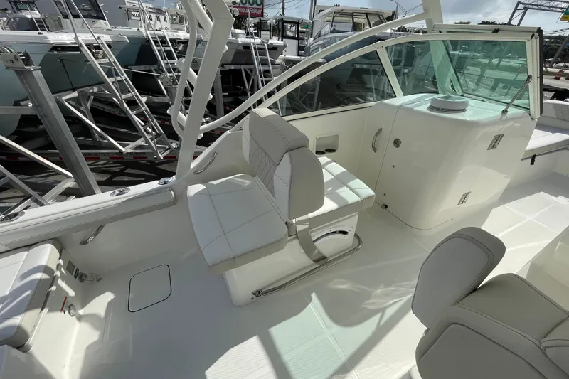 Slide: The Image of 2025 World Cat 230 DC boat interior with white seating and modern design. - 7