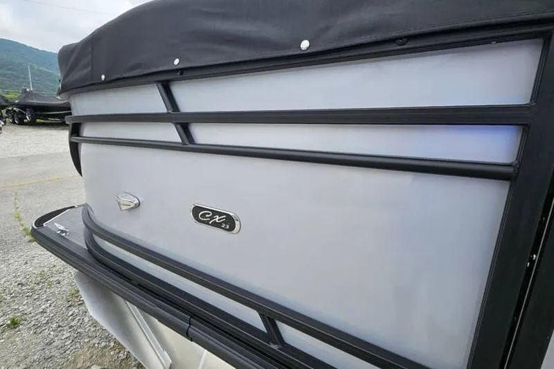 Slide: The Image of 2024 Starcraft CX 23 RL boat, side view with sleek design and logo. - 4