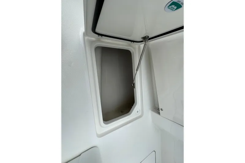 Slide: The Image of Open storage compartment on 2026 World Cat 235 TE boat interior. - 15