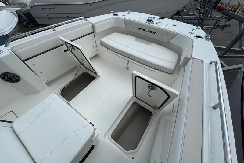 Slide: The Image of 2026 World Cat 235 TE boat interior with open storage compartments and seating. - 16