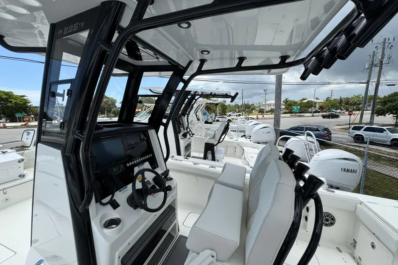 Slide: The Image of 2026 World Cat 235 TE boat interior with modern helm and seating, featuring Yamaha engines. - 3