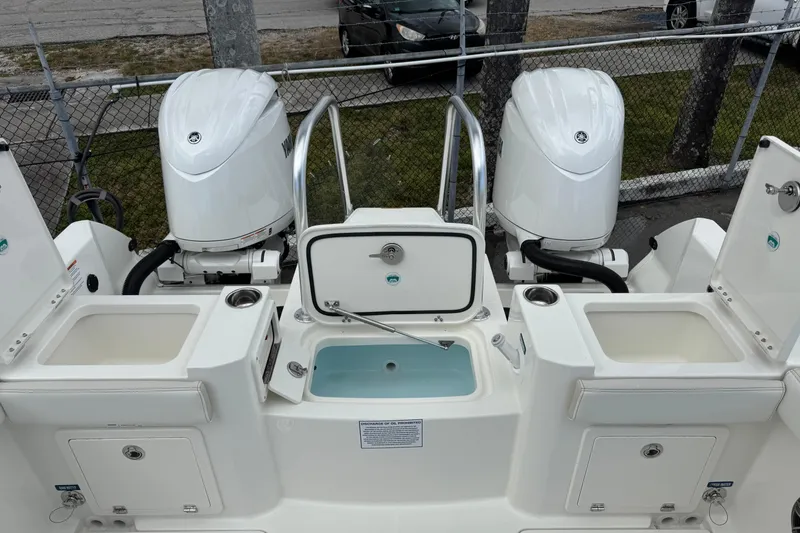 Slide: The Image of 2026 World Cat 235 TE boat with dual outboard engines and storage compartments. - 5