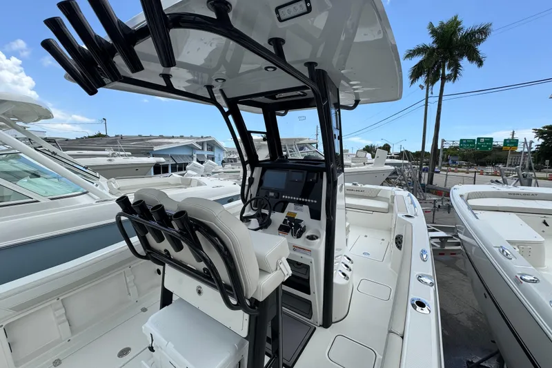 Slide: The Image of 2026 World Cat 235 TE boat interior with helm, rod holders, and seating. - 7