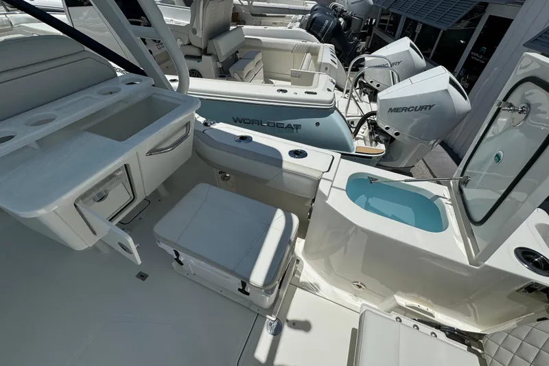 Slide: The Image of 2026 World Cat 265 DC-X boat interior with seating, storage, and Mercury engines. - 11
