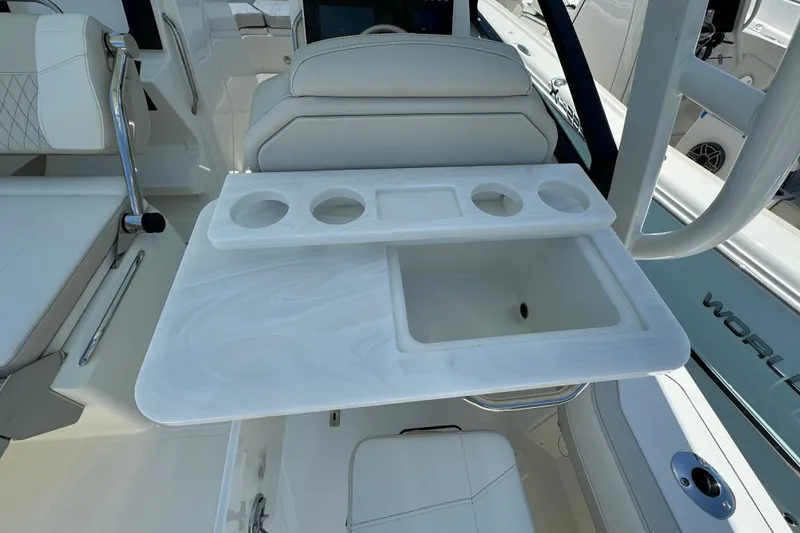 Slide: The Image of 2026 World Cat 265 DC-X boat interior with white seating and integrated cup holders. - 12