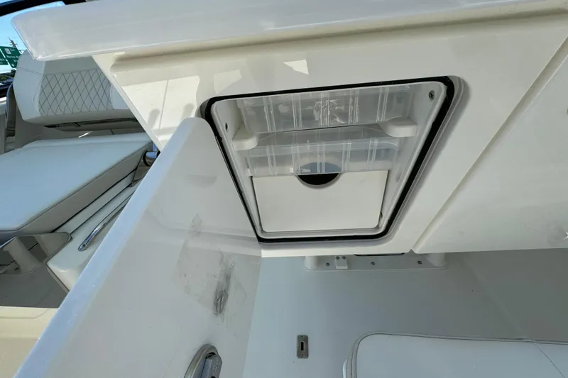 Slide: The Image of 2026 World Cat 265 DC-X boat storage compartment with open hatch and seating. - 13