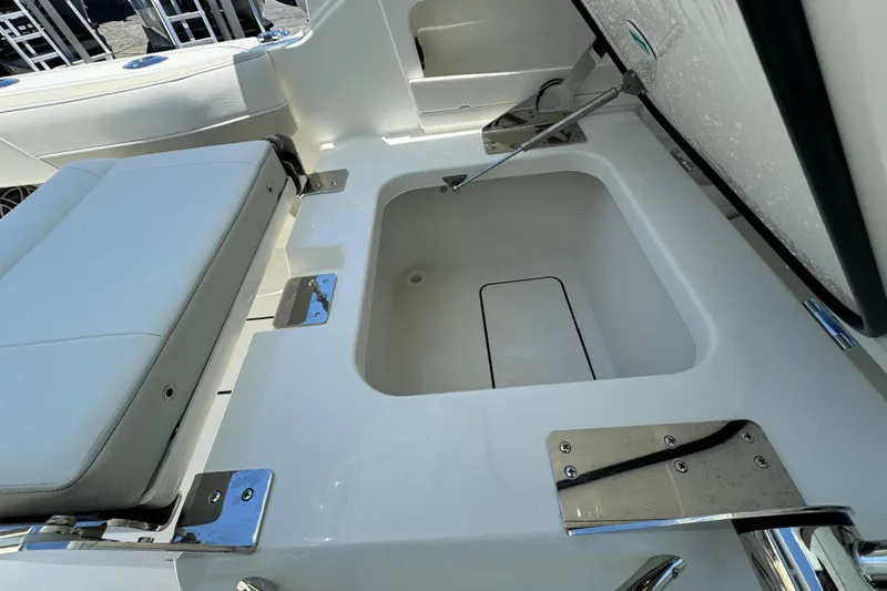 Slide: The Image of 2026 World Cat 265 DC-X boat storage compartment with cushioned seating and stainless steel hardware. - 15