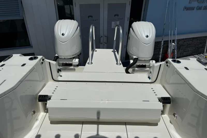 Slide: The Image of 2026 World Cat 265 DC-X boat with dual outboard engines, rear view. - 18