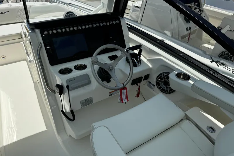 Slide: The Image of 2026 World Cat 265 DC-X boat cockpit with steering wheel and control panel. - 22
