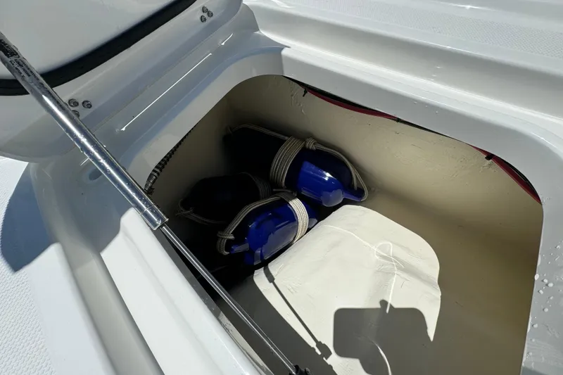 Slide: The Image of Storage compartment in 2026 World Cat 265 DC-X boat with blue fenders. - 24
