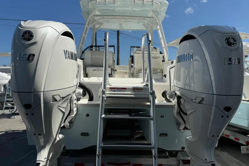 Slide: The Image of 2026 World Cat 265 DC-X boat with dual Yamaha 150 engines, ladder, and seating. - 3