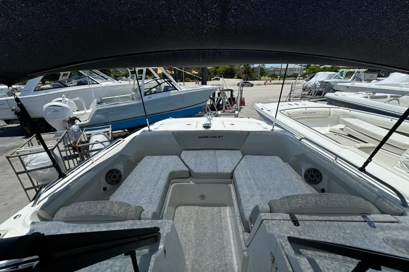 Slide: The Image of 2026 World Cat 265 DC-X boat interior with seating and speakers at a marina. - 6