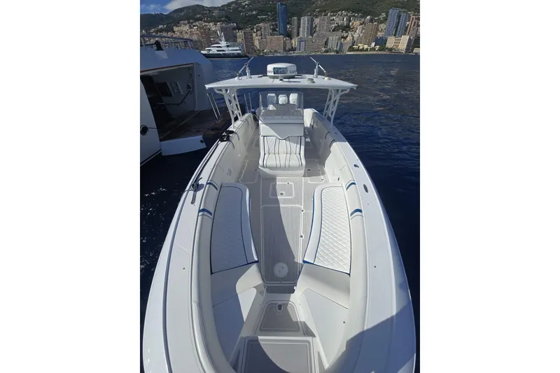 Slide: The Image of 2014 Midnight Express 37 EXK boat with sleek design, docked near cityscape. - 11