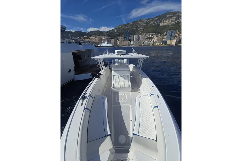 Slide: The Image of 2014 Midnight Express 37 EXK boat on water with cityscape and mountains in background. - 12