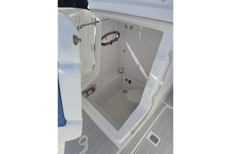 Slide: The Image of Interior of 2014 Midnight Express 37 EXK boat, featuring a compact marine toilet. - 13