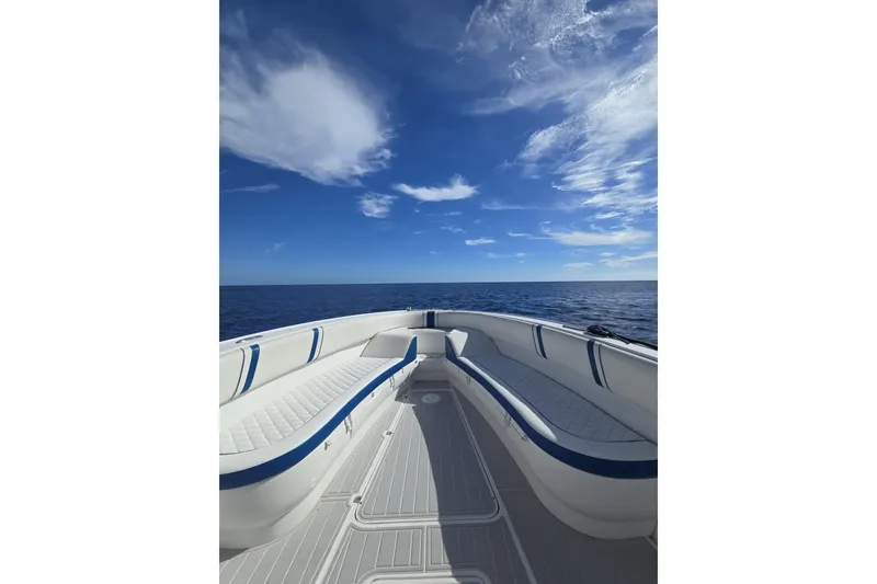 Slide: The Image of 2014 Midnight Express 37 EXK boat on open sea under clear blue sky. - 15