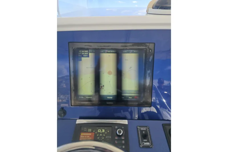 Slide: The Image of Dashboard of a 2014 Midnight Express 37 EXK boat with navigation display. - 24
