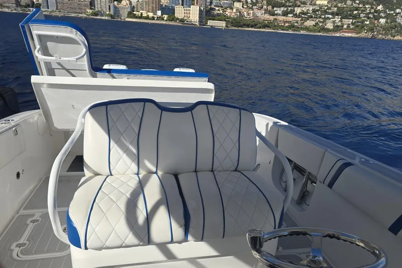 Slide: The Image of Luxurious seating on 2014 Midnight Express 37 EXK boat with ocean and cityscape backdrop. - 25