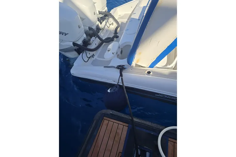 Slide: The Image of 2014 Midnight Express 37 EXK boat with Mercury engines docked on water. - 29