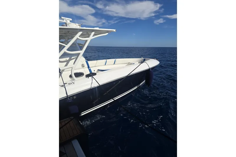 Slide: The Image of 2014 Midnight Express 37 EXK boat on open sea under clear sky. - 32