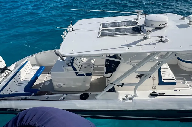 Slide: The Image of 2014 Midnight Express 37 EXK boat on clear blue water, featuring sleek design and modern equipment. - 8