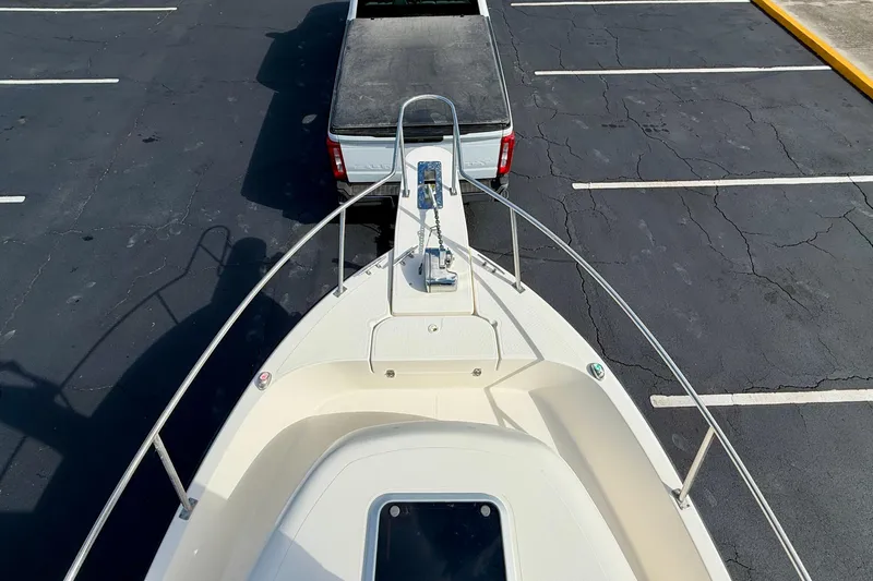 Slide: The Image of 1999 Pursuit 2470 Walkaround boat on trailer, parked in a lot, viewed from above. - 10