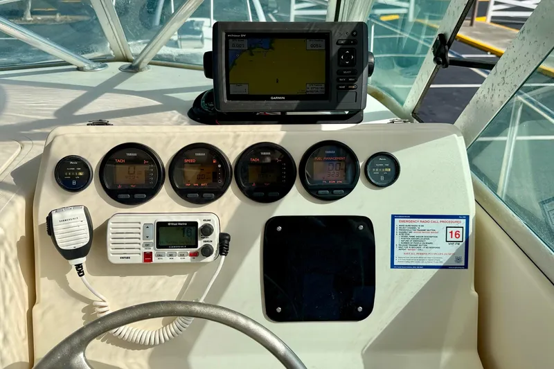 Slide: The Image of 1999 Pursuit 2470 Walkaround boat dashboard with gauges and navigation equipment. - 21