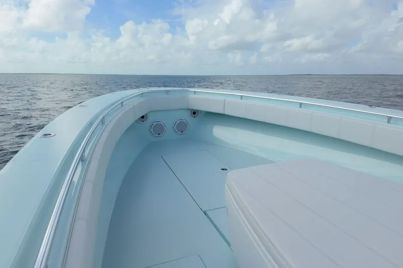 Slide: The Image of 2025 Contender 39 ST boat on open water under a cloudy sky. - 10