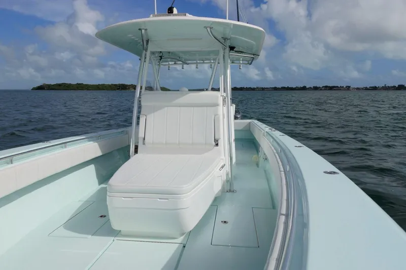 Slide: The Image of 2025 Contender 39 ST boat on open water under a cloudy sky. - 12