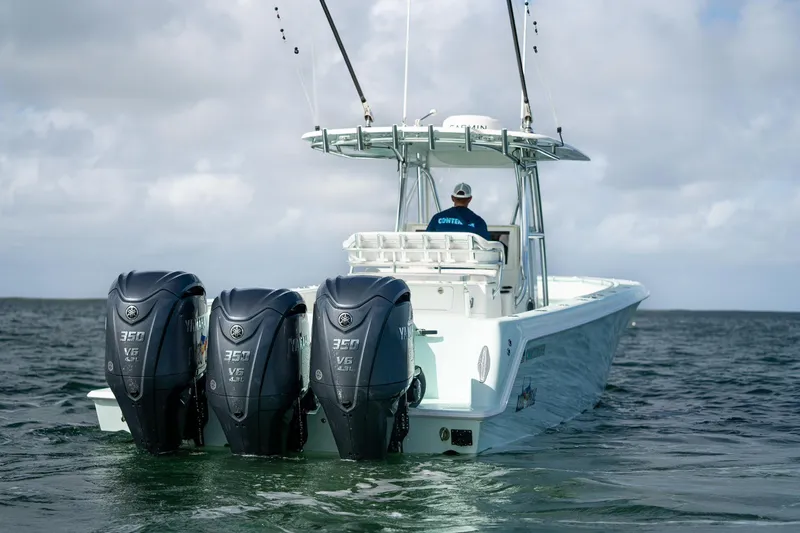 Slide: The Image of 2025 Contender 39 ST boat with triple Yamaha 350 V6 engines on open water. - 3