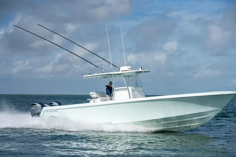 Slide: The Image of 2025 Contender 39 ST boat cruising on open water under a cloudy sky. - 4