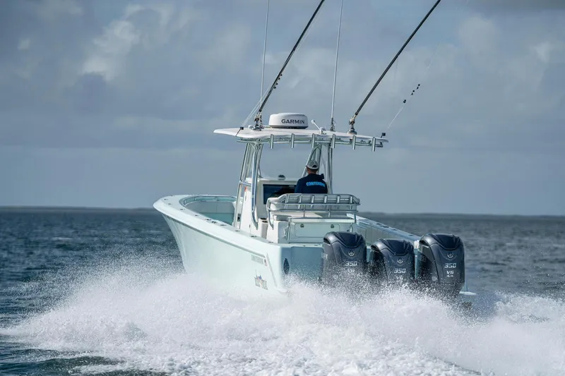 Slide: The Image of 2025 Contender 39 ST boat cruising on open water with triple engines. - 6