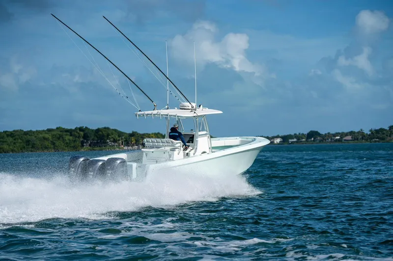 Slide: The Image of 2025 Contender 39 ST boat speeding on open water with fishing rods. - 7