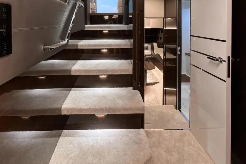 Slide: The Image of Luxurious interior of 2025 Cobrey 52 FLY yacht with illuminated staircase. - 14