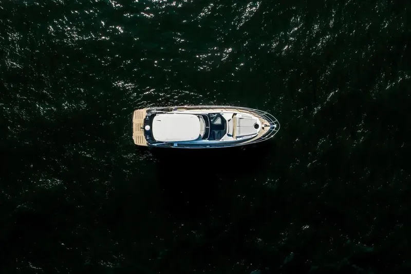 Slide: The Image of Aerial view of 2025 Cobrey 52 FLY yacht on dark water. - 7